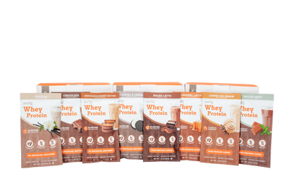 Multiple packages of whey protein on a white background